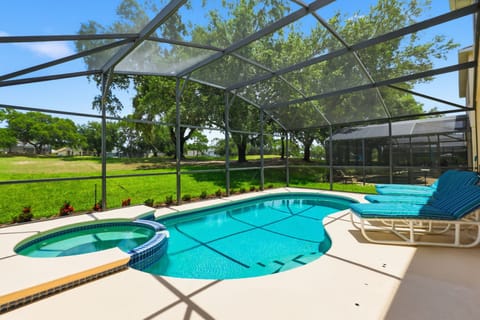 Relax poolside with peaceful views overlooking the golf course behind the home.