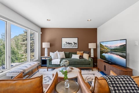 Living room with fireplace, smart tv, and stunning mountain views
