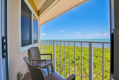 Pull up a chair and stay a while — your private balcony overlooks the water from every angle.
