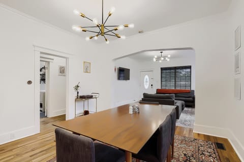 Gather around this inviting dining table where meals become memories. The open layout flows seamlessly into the cozy living area, perfect for relaxed evenings together.