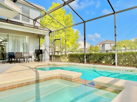Screened-in backyard oasis with a private swimming pool and bubbling spa.