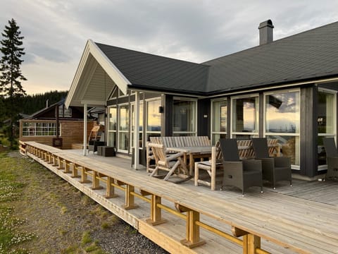 Large terrace with outdoor furniture and a fireplace