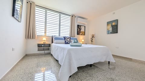 Bright modern bedroom with AC, natural light, and a clean airy design
