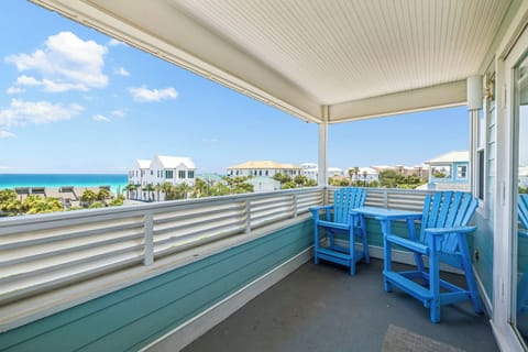 Your private balcony awaits with iconic blue Adirondack chairs, perfect for morning coffee or sunset cocktails while taking in stunning ocean views and coastal breezes.