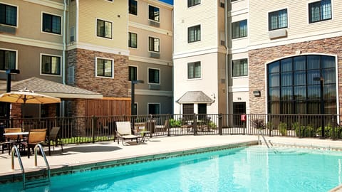 Poolside seating under umbrellas during the outdoor pool season, June through August