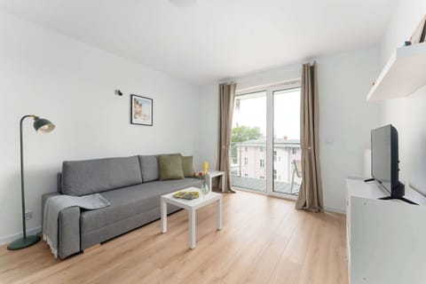 Relax in the stylish living room with a comfortable sofa and modern decor.
