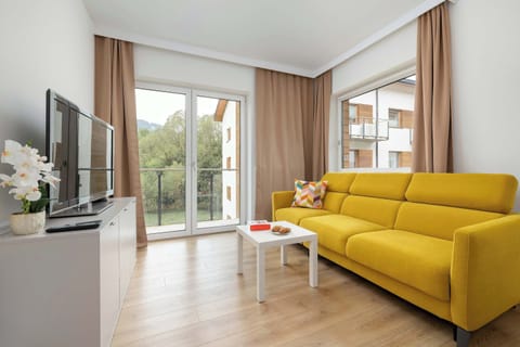 Relax in the stylish living room with a comfortable sofa and modern decor.