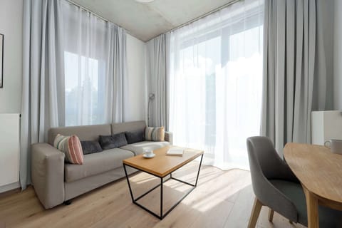 Relax in the stylish living room with a comfortable sofa and modern decor.