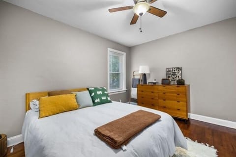 Cozy bedroom featuring hardwood floors and natural light
