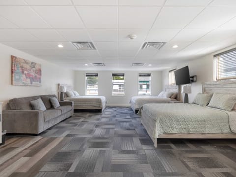 Three queen beds and a pull-out sofa couch