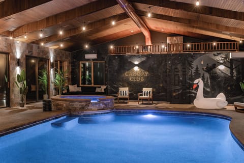 {Indoor Pool House} Your private mountain resort starts here—swim year-round beneath soaring wood beams, then soak in the bubbling hot tub surrounded by the forest-inspired Canopy Club mural.