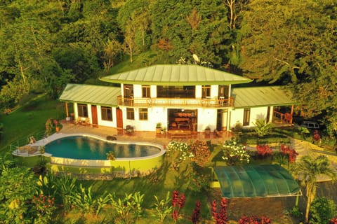 Evening aerial of Casa Infinity — villa and infinity pool at dusk