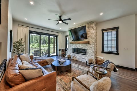 Living room with fireplace, smart tv, and walkout patio