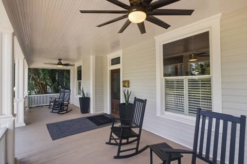 The Southern Handshake: Six stately black acacia rockers sit in perfect symmetry, framing the grand historic entryway and inviting you to slow down and enjoy the breeze.