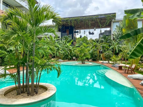 Start your day by a private pool surrounded by tropical greenery