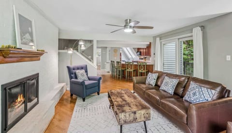 Open-concept living room with gas fireplace and hardwood floors