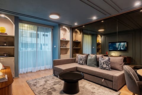 Stylish living area with a sofa and TV, perfect to unwind.