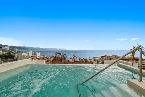 Trendy Zona Romántica studio with king bed, full kitchen & AC. Steps to Los Muertos beach with access to this jaw-dropping heated rooftop infinity pool & ocean views.