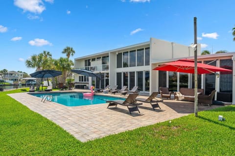 Large tropical backyard with riverfront heated pool