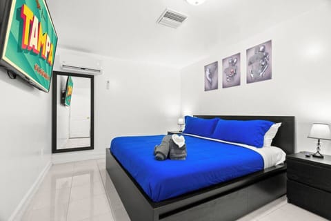 Plush king bed with fresh linens and large smart TV for ultimate comfort.