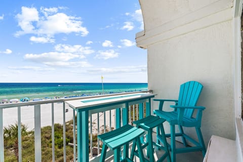 Step onto your private balcony and breathe in the ocean breeze—your beachfront escape awaits with vibrant turquoise waters just steps away.