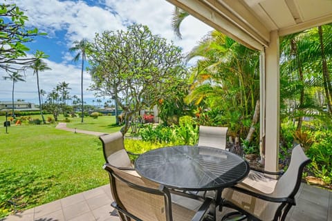 Enjoy your morning coffee on your private patio, surrounded by lush tropical palms and serene garden views that invite relaxation.