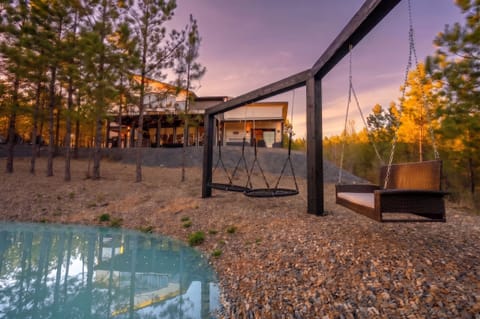 Dusk views, forest serenity, and unique swing seating by the pond