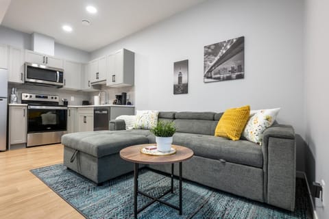 Cozy modern lounge with sectional seating and sleek full kitchen
