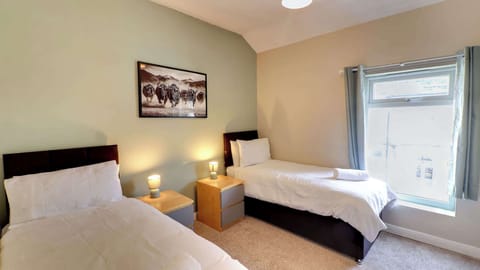A comfortable twin room offering a great night's sleep after a long day's work, with quality beds, soft lighting and plenty of space to relax.
