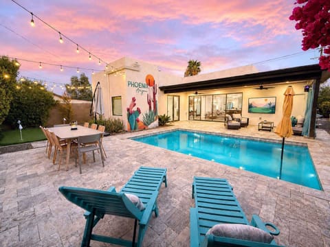 Resort-Style Backyard, Pool, BBQ, Putting Green, Smart TV,  String Lights, and Covered Lounge Deck at Twilight