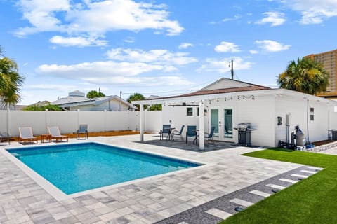 Your private resort-style backyard includes a sparkling pool, covered patio, and BBQ grill for outdoor dining.