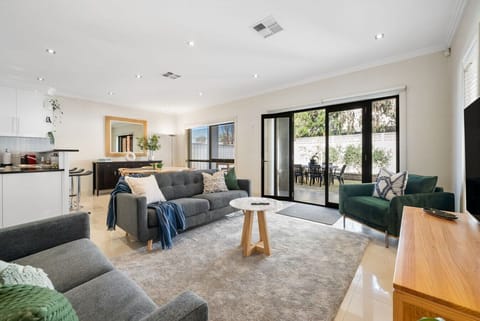 Stretch out on comfortable sofas and enjoy your favourite shows on the large TV, with bi-fold doors opening effortlessly to the patio.