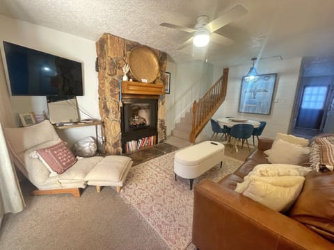 Sink into plush seating by your stone fireplace and unwind after a day exploring. The cozy layout invites relaxation, while natural light and warm tones make this your perfect mountain retreat.