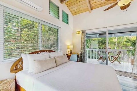 Sleeping area includes queen bed ceiling fan and garden views