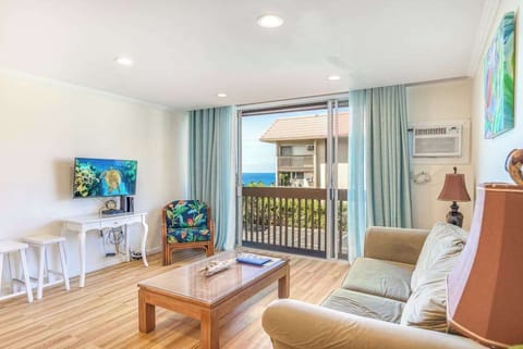 Bright Living Room with Sofa Seating, Smart TV, and Balcony Access