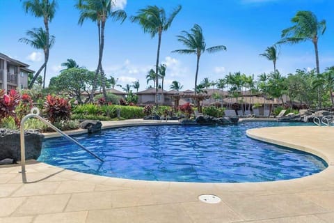 Resort-style pool surrounded by tropical palms
