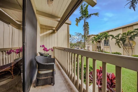 Private wooden balcony with comfortable seating overlooking the tropical courtyard. ☀️🌴
