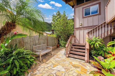 Welcome to a charming home entrance surrounded by tropical greenery