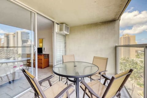 Private balcony with outdoor dining and relaxing Waikiki city views, perfect for morning coffee or sunset drinks.