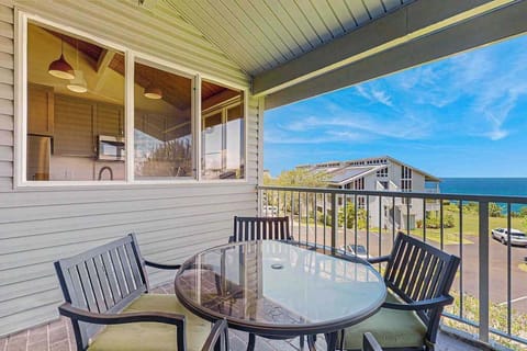 Large lanai with tropical views and seating for four.