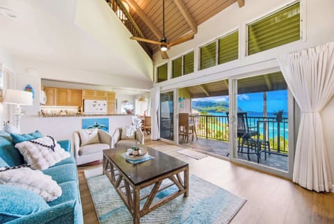 Open lounge presents stylish furnishings beside windows overlooking scenic island landscapes
