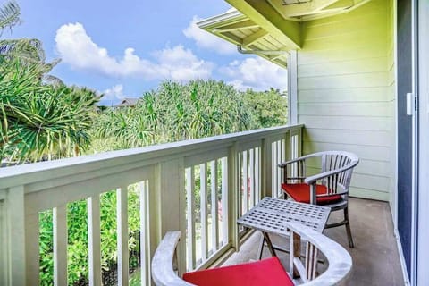 Private lanai surrounded by lush tropical paradise, vibrant flowers, and swaying palms—the perfect place to relax and soak in the island atmosphere.