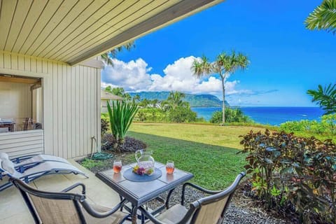 Covered patio showcases tiled flooring, bistro seating, and mountain views