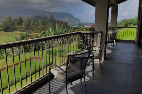Covered balcony offers seating, garden views, and peaceful outdoor relaxation
