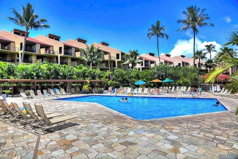 Refreshing resort pool surrounded by tropical scenery