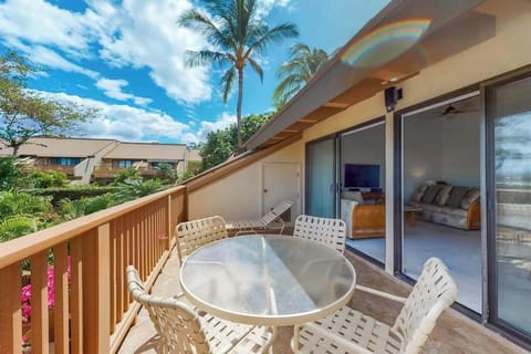 Balcony dining seating frames mountain vistas and vibrant tropical landscaping