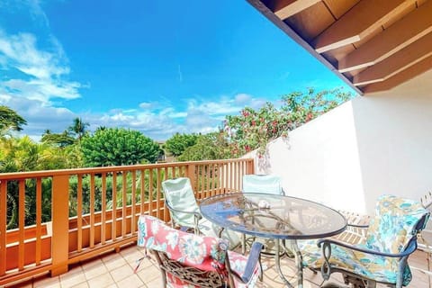 Balcony seating invites morning coffee beside tropical greenery and breezes