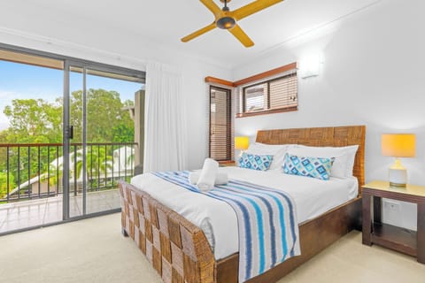 Wake to leafy outlooks from the primary bedroom, featuring a king bed and direct access to a private balcony that welcomes the morning breeze.