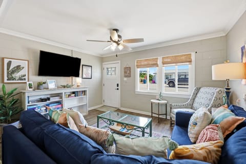 Sink into plush sofas and unwind in your bright, welcoming living space, where a ceiling fan keeps you comfortable and cheerful décor sets the perfect tone for relaxation.