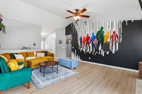 Gather together in the bright, open living room featuring a large sectional, cozy accent seating, and plenty of space for everyone to relax after a day of exploring St. Louis.